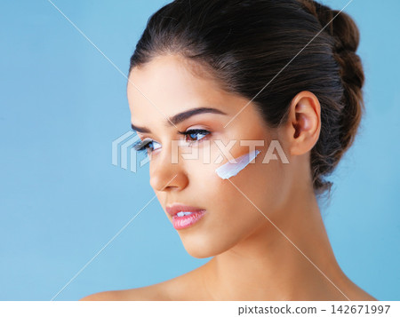 Thinking, skincare and girl with face cream in studio mockup for wellness, cosmetics or skin detox on blue background. Beauty, sunscreen or model with how to, tips or diy makeup removal product idea Thinking, skincare and girl with face cream in studio mockup for wellness, cosmetics or skin detox on blue background. Beauty, sunscreen or model with how to, tips or diy makeup removal product idea 142671997