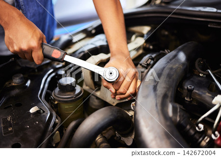 Person, hands and mechanic with spanner for fixing engine in workshop for motor maintenance and service. Industry, engineer and vehicle repairs with oil change in garage for routine car checkup Person, hands and mechanic with spanner for fixing engine in workshop for motor maintenance and service. Industry, engineer and vehicle repairs with oil change in garage for routine car checkup 142672004