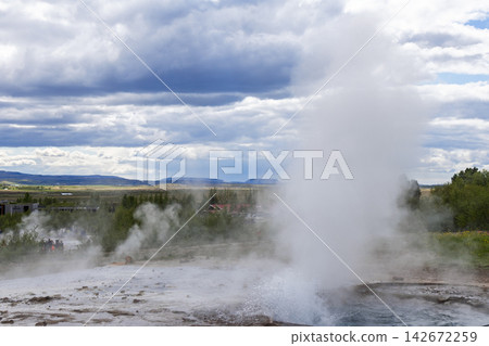 Strokkur geyser steam plume above wet mineral ground in Haukadalur, Iceland Strokkur geyser steam plume above wet mineral ground in Haukadalur, Iceland 142672259