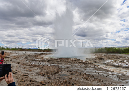 Strokkur geyser eruption in Haukadalur beneath an overcast Iceland sky Strokkur geyser eruption in Haukadalur beneath an overcast Iceland sky 142672267
