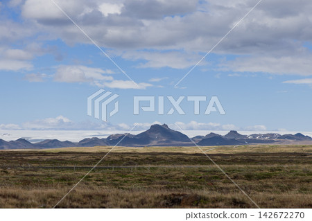 Icelandic highland landscape with a distant glacier and volcanic mountains Icelandic highland landscape with a distant glacier and volcanic mountains 142672270