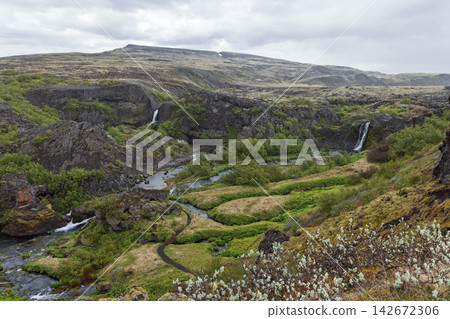 Waterfalls in the volcanic landscape of Gjain, Thjorsardalur, Iceland, elemental river and lava Waterfalls in the volcanic landscape of Gjain, Thjorsardalur, Iceland, elemental river and lava 142672306