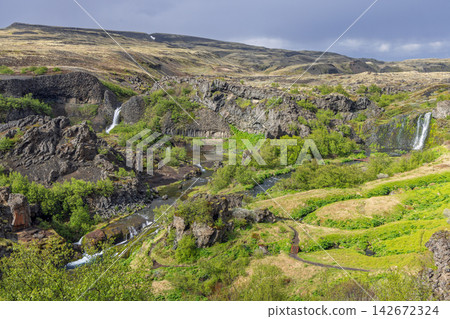 Elevated wide view of Gjain valley and waterfalls in Thjorsardalur, Iceland Elevated wide view of Gjain valley and waterfalls in Thjorsardalur, Iceland 142672324