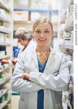 Happy, pharmacist or portrait of woman with arms crossed in healthcare clinic, pharmacy or drugstore. Proud, smile or confident medical intern by shelf for medication, pills or medicine ready to help 142672517