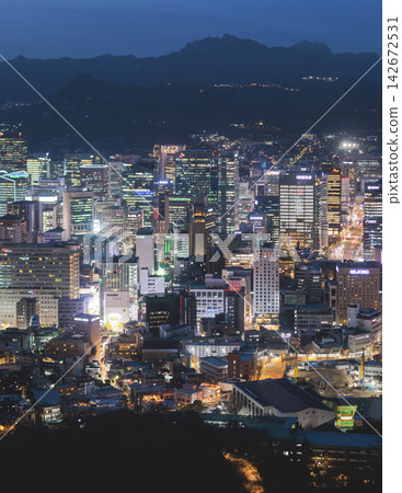 Seoul night skyline, South Korea, beautiful aerial twilight view, with mountains and scenery beyond the city, seen from observation deck of Namsan Park, Gyeonggi-do province, Republic of Korea Seoul night skyline, South Korea, beautiful aerial twilight view, with mountains and scenery beyond the city, seen from observation deck of Namsan Park, Gyeonggi-do province, Republic of Korea 142672531