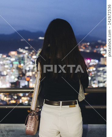Seoul night skyline, South Korea, beautiful aerial twilight view, with mountains and scenery beyond the city, seen from observation deck of Namsan Park, Gyeonggi-do province, Republic of Korea 142672536