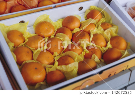 Jeju orange and hallabong for sale on farm market shop, Jeju Island, South Korea, tangerine and gamgyul fruits packed in gift orange boxes and crates, ripe citrus fruits export, Jeju-do agriculture 142672585
