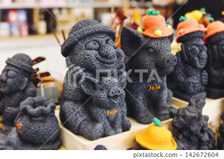 Tourist gifts and Korean souvenirs from Jeju Island, Jeju-do, South Korea, tangerine hallabong figures in orange color, knitted toys, fridge magnets, key ring keychain, a local gift vendor shop market Tourist gifts and Korean souvenirs from Jeju Island, Jeju-do, South Korea, tangerine hallabong figures in orange color, knitted toys, fridge magnets, key ring keychain, a local gift vendor shop market 142672604