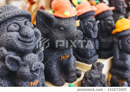 Tourist gifts and Korean souvenirs from Jeju Island, Jeju-do, South Korea, tangerine hallabong figures in orange color, knitted toys, fridge magnets, key ring keychain, a local gift vendor shop market 142672605