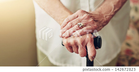 Hands, walking stick and closeup with senior woman, injury and disabled with balance in retirement in house. Cane, elderly lady and person with disability, support or recovery in home with lens flare Hands, walking stick and closeup with senior woman, injury and disabled with balance in retirement in house. Cane, elderly lady and person with disability, support or recovery in home with lens flare 142672823