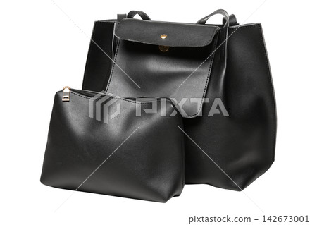 Black faux leather tote bag set with matching cosmetics pouch on white background Black faux leather tote bag set with matching cosmetics pouch on white background 142673001