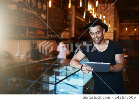 Tablet, man and coffee shop with creative job and digital freelancer planning a social media post or blog. Smile, restaurant and tech with happy writer with remote work at cafe with internet 142673509