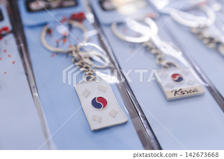 Tourist gifts and Korean souvenirs from South Korea, toys and figurines, fridge magnets and key ring keychain, key fobs and postcards with symbols of South Korea in a local gift vendor shop market Tourist gifts and Korean souvenirs from South Korea, toys and figurines, fridge magnets and key ring keychain, key fobs and postcards with symbols of South Korea in a local gift vendor shop market 142673668