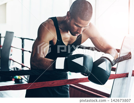 Tired, boxer and man in ring at gym for challenge, exercise and fail competition in training for body health. Stress, fight and sport athlete resting on break with fatigue for fitness or depression Tired, boxer and man in ring at gym for challenge, exercise and fail competition in training for body health. Stress, fight and sport athlete resting on break with fatigue for fitness or depression 142673807