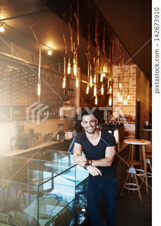 Happy, coffee shop and portrait of man by counter ready for serving caffeine, drinks and beverage for small business. Restaurant, hospitality and confident waiter for service, help or welcome in cafe 142673910