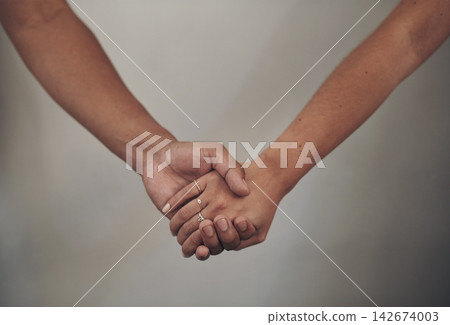 Couple, love and holding hands for support, care and solidarity or romance with studio background. Compassion, partnership or relationship for people, marriage or hope or trust for affection together Couple, love and holding hands for support, care and solidarity or romance with studio background. Compassion, partnership or relationship for people, marriage or hope or trust for affection together 142674003