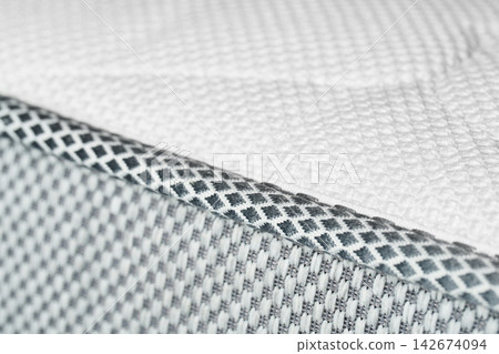 The macrotexture of the white edging and the fabric of the orthopedic mattress. The macrotexture of the white edging and the fabric of the orthopedic mattress. 142674094