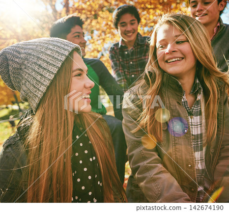 Talking, happy and friends outdoor in park for relaxing day on summer vacation of semester break, together and bonding. Group, diversity and trees in garden on holiday in New Zealand and lens flare. Talking, happy and friends outdoor in park for relaxing day on summer vacation of semester break, together and bonding. Group, diversity and trees in garden on holiday in New Zealand and lens flare. 142674190