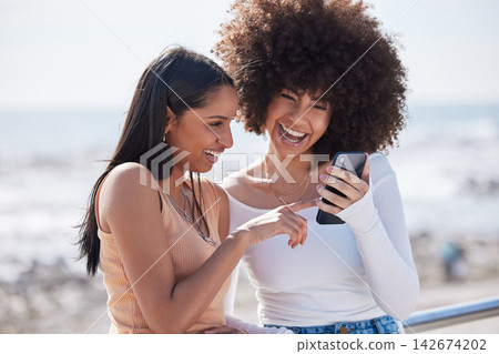 Girl friends, phone and laugh by the sea with text and meme on holiday with student travel in Miami. Mobile, app and gossip with funny women by the ocean online on the internet together in summer Girl friends, phone and laugh by the sea with text and meme on holiday with student travel in Miami. Mobile, app and gossip with funny women by the ocean online on the internet together in summer 142674202