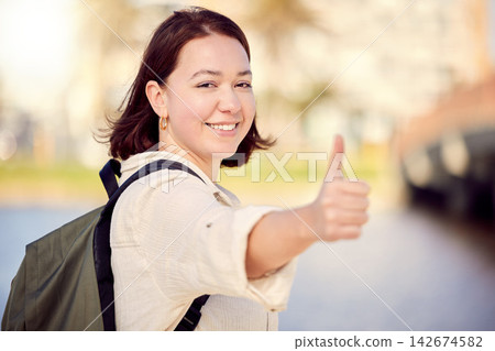 Portrait, tourist or happy woman in city with thumbs up for travel, good news or like for hiking on street road. Positive, hand gesture or girl with thank you smile, yes sign or vote for okay review 142674582