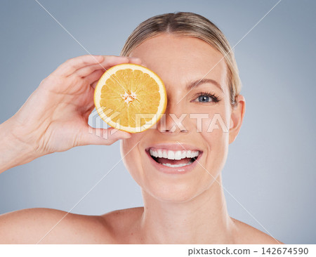 Skincare, orange fruit and portrait of woman in studio for facial treatment, natural glow or wellness on white background. Smile, beauty and hand of model for vitamin c, eco friendly or dermatology Skincare, orange fruit and portrait of woman in studio for facial treatment, natural glow or wellness on white background. Smile, beauty and hand of model for vitamin c, eco friendly or dermatology 142674590