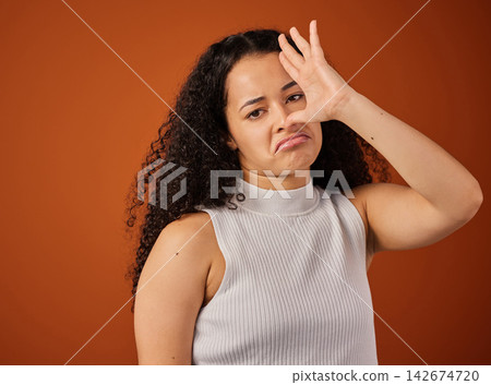 Funny, bad smell and portrait of woman in studio with silly facial expression for quirky emotion. Goofy, upset and female person from Colombia with unsure face for stink aroma by color background. Funny, bad smell and portrait of woman in studio with silly facial expression for quirky emotion. Goofy, upset and female person from Colombia with unsure face for stink aroma by color background. 142674720