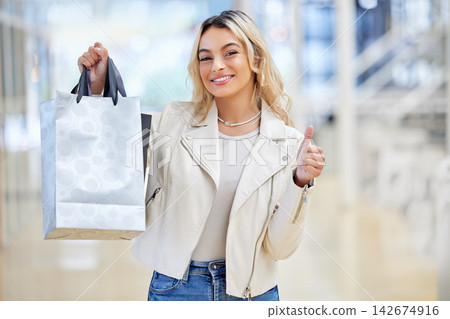 Shopping bag, thumbs up or happy woman in celebration in mall for yes icon, present or sale in boutique. Smile. okay sign or rich customer with hand gesture for deal promo offer on fashion discount Shopping bag, thumbs up or happy woman in celebration in mall for yes icon, present or sale in boutique. Smile. okay sign or rich customer with hand gesture for deal promo offer on fashion discount 142674916