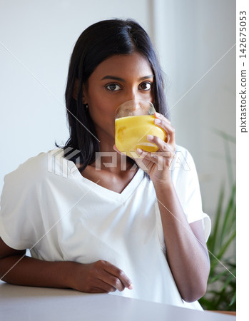 Portrait, home and Indian woman with juice, drink and nutrition to enjoy, healthy and apartment of girl. House, person and model with glass of natural liquid, morning and beverage for vitamin c Portrait, home and Indian woman with juice, drink and nutrition to enjoy, healthy and apartment of girl. House, person and model with glass of natural liquid, morning and beverage for vitamin c 142675053