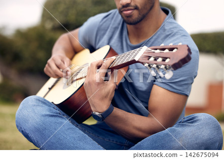 Man, hands and guitar in garden for music, sound and performance in nature. Male person, musician and playing instrument in backyard for practice, production and rehearsal for college talent show 142675094