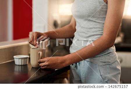 Tea, hands and person in kitchen for enjoyment, relax and herbal drink on counter at home. Woman, brewing and sugar in mug for warm beverage in house for detox, cleanse and organic for health Tea, hands and person in kitchen for enjoyment, relax and herbal drink on counter at home. Woman, brewing and sugar in mug for warm beverage in house for detox, cleanse and organic for health 142675157