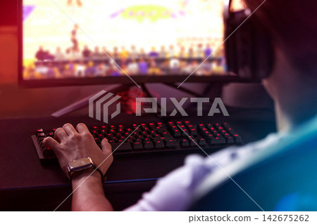 Gamer, computer screen and man with headset, live stream and esports subscription from back. Content creator, influencer or streamer with headphones for online challenge, video game or night at home. Gamer, computer screen and man with headset, live stream and esports subscription from back. Content creator, influencer or streamer with headphones for online challenge, video game or night at home. 142675262