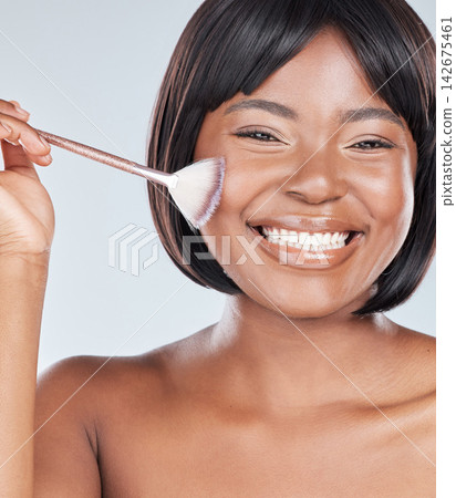 African woman, makeup brush and portrait in studio with smile, beauty and foundation by background. Girl, person and happy with tools, cosmetics and product for facial skin with powder for aesthetic African woman, makeup brush and portrait in studio with smile, beauty and foundation by background. Girl, person and happy with tools, cosmetics and product for facial skin with powder for aesthetic 142675461
