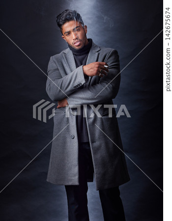 Fashion, man smoking and dark studio with serious mafia leader, holding cigarette and cool stylish winter coat. Mysterious, trendy and edgy smoke for Indian mob, black background and confident model Fashion, man smoking and dark studio with serious mafia leader, holding cigarette and cool stylish winter coat. Mysterious, trendy and edgy smoke for Indian mob, black background and confident model 142675674