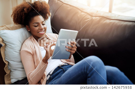 Woman, browse and home or smile on tablet, relax and internet communication or social media scrolling. Reading, text and blog or online networking, typing and happy on tech on sofa in apartment Woman, browse and home or smile on tablet, relax and internet communication or social media scrolling. Reading, text and blog or online networking, typing and happy on tech on sofa in apartment 142675938