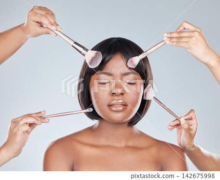 Brush, makeup and face of black woman for beauty, wellness and cosmetics in studio. Cosmetology, skincare and isolated person with brushes for application, foundation and products on white background Brush, makeup and face of black woman for beauty, wellness and cosmetics in studio. Cosmetology, skincare and isolated person with brushes for application, foundation and products on white background 142675998