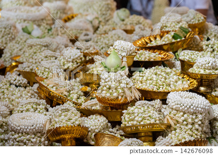 People offer jasmine flower garlands to the revered Luang Pho Tan Jai (Buddha of Success) statue at Wat Phra That Doi Kham in Chiang Mai to make or fulfill wishes for luck, wealth, and career success. People offer jasmine flower garlands to the revered Luang Pho Tan Jai (Buddha of Success) statue at Wat Phra That Doi Kham in Chiang Mai to make or fulfill wishes for luck, wealth, and career success. 142676098