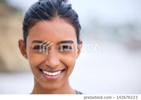 Indian woman, portrait and happiness at beach for vacation, travel and weekend for relax in nature. Happy, female yoga instructor, healthy and outside for retreat, holiday and adventure in summer 142676223