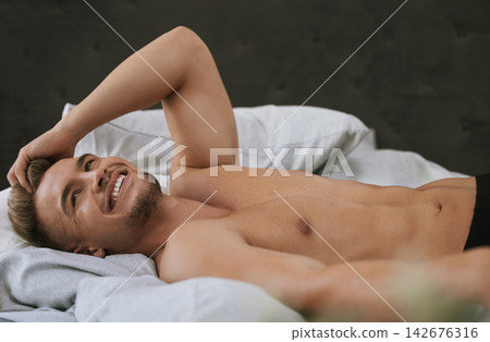 Morning, wake up or happy man in bedroom thinking of resting in home, house or apartment. Topless, relax or calm male person sleeping on break with smile or ready to start day or chill on weekend Morning, wake up or happy man in bedroom thinking of resting in home, house or apartment. Topless, relax or calm male person sleeping on break with smile or ready to start day or chill on weekend 142676316