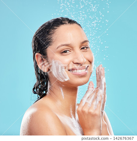 Shower, cleaning and portrait of happy woman for skincare, hygiene or wellness isolated on blue studio background. Water splash, soap bath and face of model for dermatology, health or wash for beauty Shower, cleaning and portrait of happy woman for skincare, hygiene or wellness isolated on blue studio background. Water splash, soap bath and face of model for dermatology, health or wash for beauty 142676367