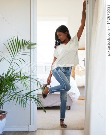 Fashion, woman and happy with shoes for getting ready in morning for college at apartment. Female person or student and smile with sandal for dressing or preparation before university class at home Fashion, woman and happy with shoes for getting ready in morning for college at apartment. Female person or student and smile with sandal for dressing or preparation before university class at home 142676552