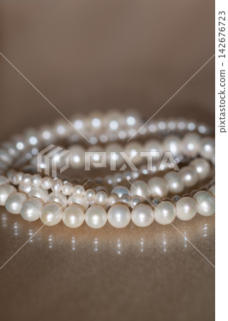 Elegant Pearl Necklace on Dark background, Glass Surface wit Reflection. Elegant Pearl Necklace on Dark background, Glass Surface wit Reflection. 142676723