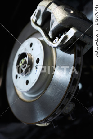 Car, brake and tyre for maintenance in workshop with inspection of disc system for service by mechanic. Vehicle, suspension and expert technician for check, repair and balance of wheel for safety Car, brake and tyre for maintenance in workshop with inspection of disc system for service by mechanic. Vehicle, suspension and expert technician for check, repair and balance of wheel for safety 142676748