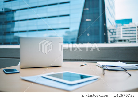 Rooftop, laptop and smartphone with tablet on desk for communication, planning and research. Still life, spectacles and technology on outdoor table for ecommerce, social media and internet search Rooftop, laptop and smartphone with tablet on desk for communication, planning and research. Still life, spectacles and technology on outdoor table for ecommerce, social media and internet search 142676753