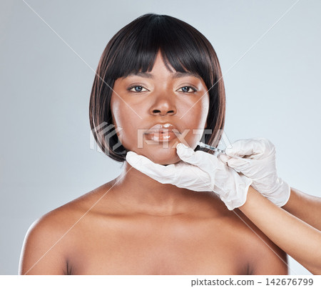 Hands, African woman and syringe for lip filler in studio for plastic surgery, beauty or change by white background. Girl, portrait and chemical for cosmetics, injection and liquid for transformation 142676799