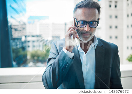 Window, businessman and phone call for networking with communication, negotiation and contact in office. Professional career, mature ceo and executive director with mobile for talk, chat and speak Window, businessman and phone call for networking with communication, negotiation and contact in office. Professional career, mature ceo and executive director with mobile for talk, chat and speak 142676972