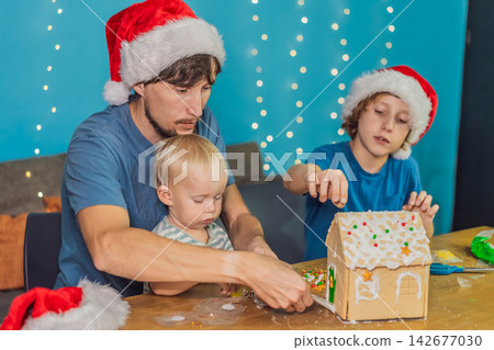 Dad helps kids make a festive gingerbread house, capturing Christmas holiday, family bonding, creativity and home celebration concept Dad helps kids make a festive gingerbread house, capturing Christmas holiday, family bonding, creativity and home celebration concept 142677030
