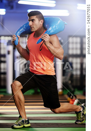 Bodybuilding, man and shoulder bag weight for fitness, exercise and strong muscle development. Weightlifting, gym workout and serious body builder in health, wellness or power training at sports club Bodybuilding, man and shoulder bag weight for fitness, exercise and strong muscle development. Weightlifting, gym workout and serious body builder in health, wellness or power training at sports club 142677031
