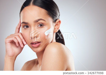 Girl, portrait and apply lotion in studio, confident and skincare glow on gray background. Female person, sunscreen and proud of moisturizer for skin hydration, cosmetics and dermatology mockup space Girl, portrait and apply lotion in studio, confident and skincare glow on gray background. Female person, sunscreen and proud of moisturizer for skin hydration, cosmetics and dermatology mockup space 142677098