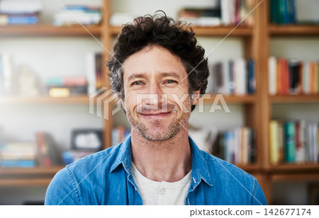 Mature man, portrait and happy in home by bookshelf with confidence, intelligence and pride for learning. Professor, lecturer and person or smile by book cabinet for knowledge, education and study Mature man, portrait and happy in home by bookshelf with confidence, intelligence and pride for learning. Professor, lecturer and person or smile by book cabinet for knowledge, education and study 142677174