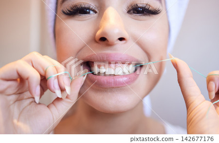 Dental, portrait and woman flossing teeth for cleaning, health or oral hygiene in home bathroom. Tooth care, happy face and thread in mouth for orthodontics, morning routine or fresh breath closeup Dental, portrait and woman flossing teeth for cleaning, health or oral hygiene in home bathroom. Tooth care, happy face and thread in mouth for orthodontics, morning routine or fresh breath closeup 142677176